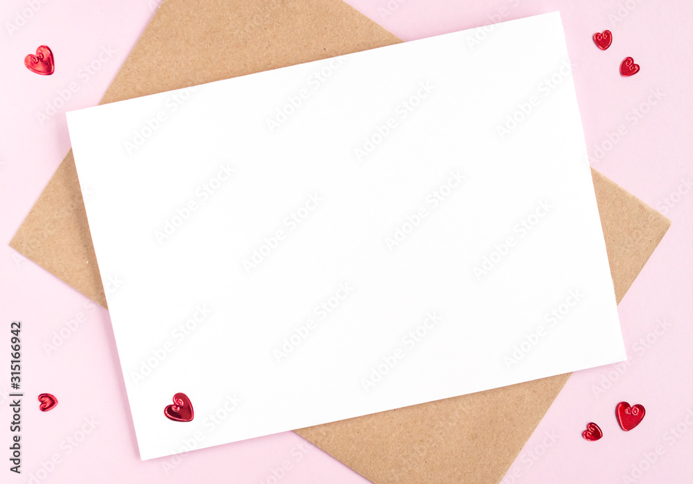Minimalistic card mockup with envelope, postcard, red hearts on pink background. Flat lay, top view, copy space. Valentines day concept.