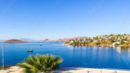 Fototapeta Naklejka Na Ścianę i Meble -  Aegean coast with marvelous blue water, rich nature, islands, mountains and small white houses