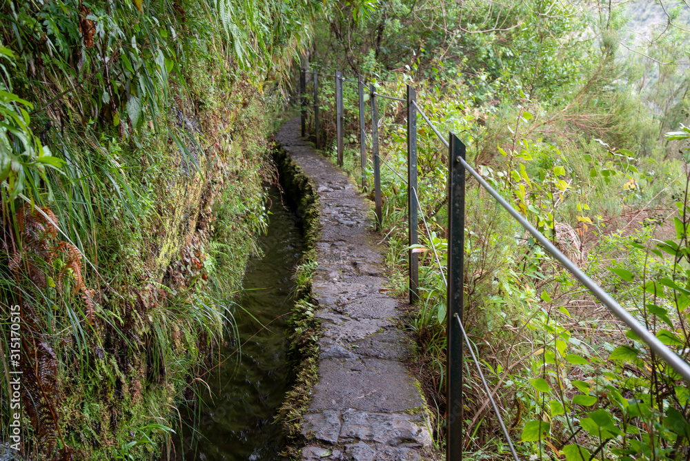 Hiking path on the Levada do Caldeirao Verde near Santana on the island of Madeira in Portugal. Hiking path on the Levada do Caldeirao Verde near Santana on the island of Madeira in Portugal.
