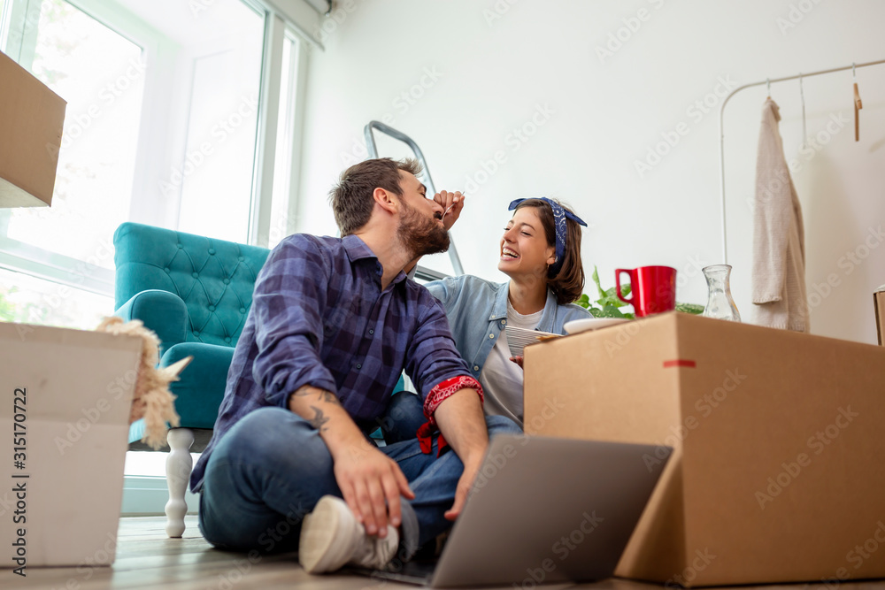 Couple having breakfast in new apartment Couple having breakfast in new apartment