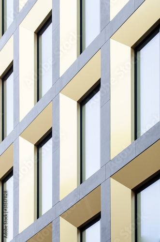 Geometric pattern from part of building facade. Modern architecture of commercial building walls and windows made of glass.