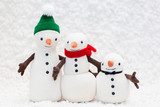 Toy snowman family on white background
