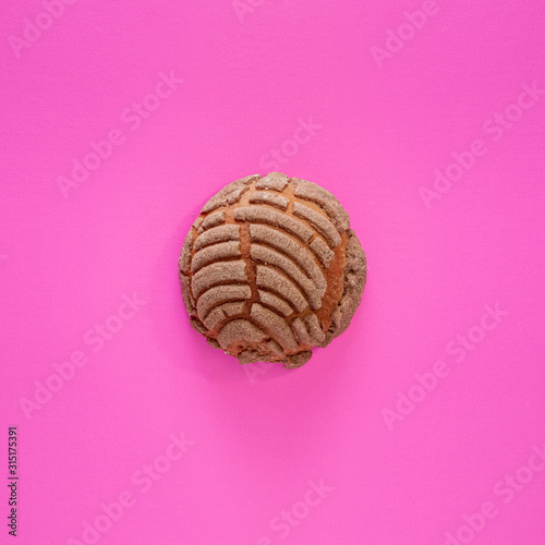 Concha Bread, Mexican Sweet Scone on Pink Surface.