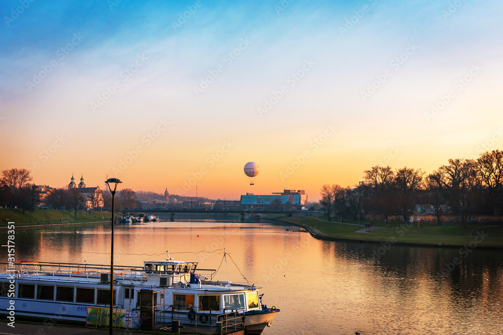 Krakow / Poland - 02 January 2020: View of the Vistula River. Sunset sky with baloon. Krakow / Poland - 02 January 2020: View of the Vistula River. Sunset sky with baloon.
