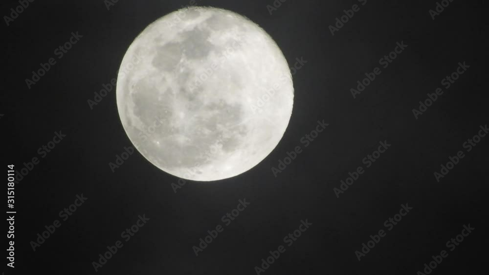 Full moon on dark cloudy night. Clouds passing by the moon, real time shot. Full moon on dark cloudy night. Clouds passing by the moon, real time shot.