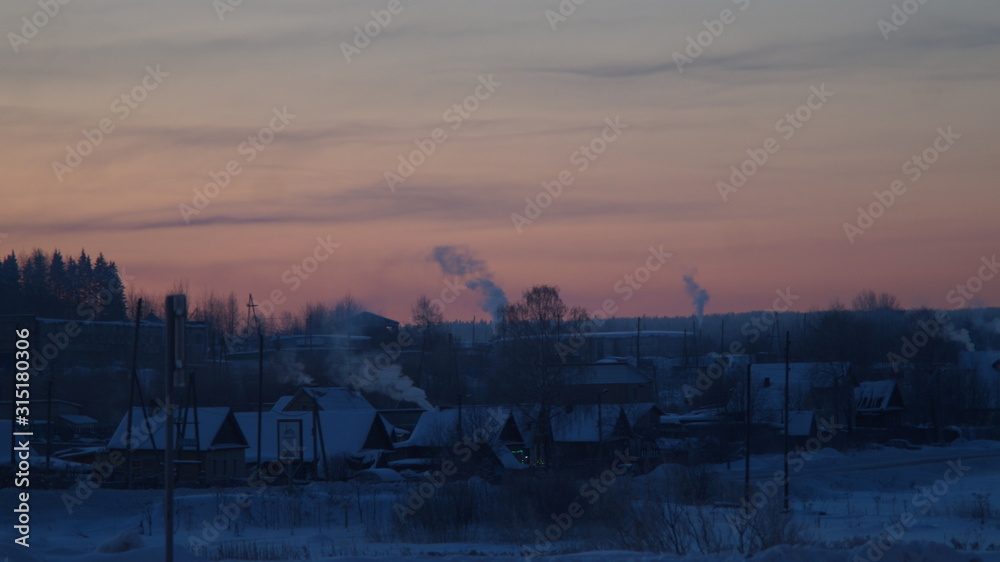 Obraz premium wooden houses against the dawn sky