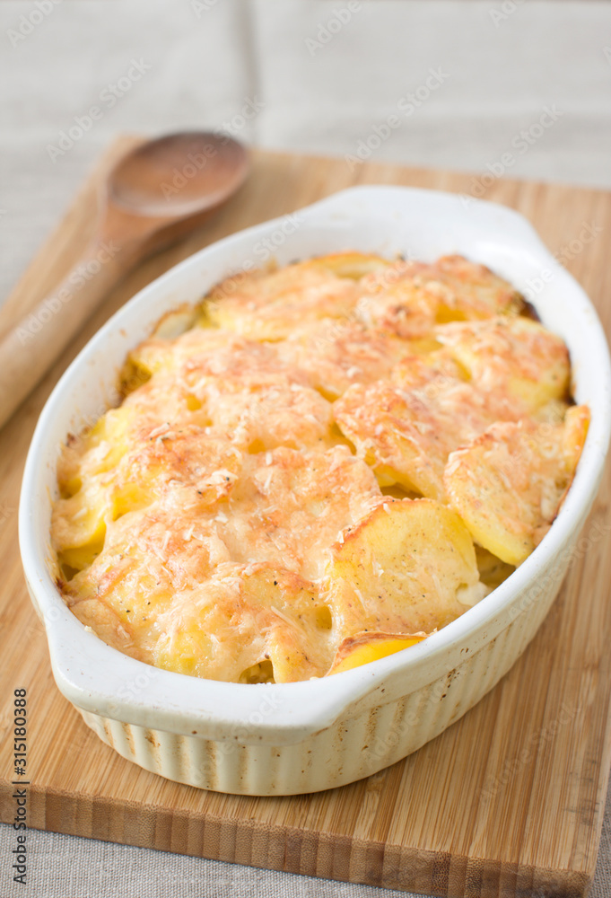 Dish of potato gratin on a table Dish of potato gratin on a table