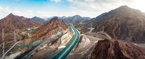 Scenic road through Hajar mountain range stretching through UAE and Oman
