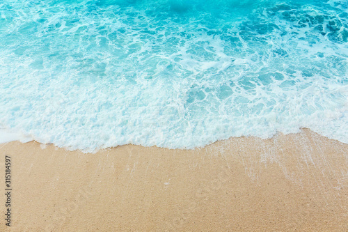 Soft beautiful ocean wave on sandy beach. Background. © Sergey
