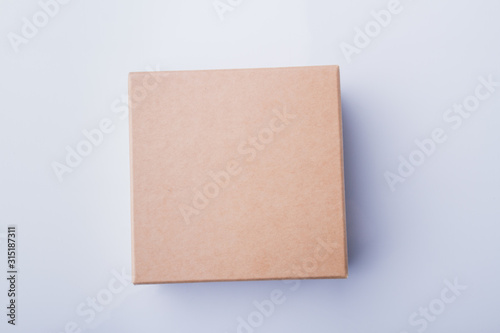 Cardboard box cover, plain macro. Top view, isolated on white. © DenisProduction.com