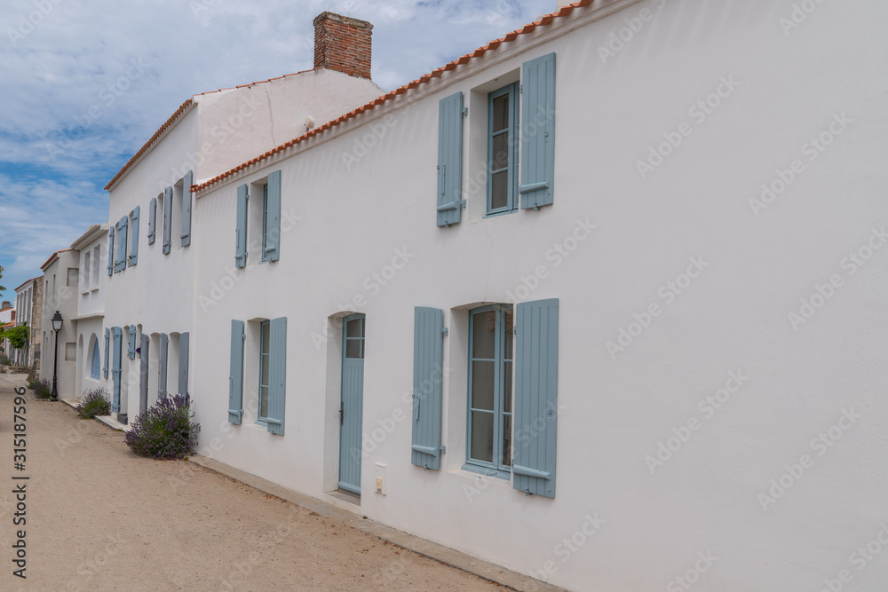 white house blue shutter in street in Noirmoutier island