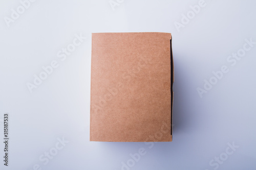 Cardboard box plain macro surface. Closed package conatiner, smooth cover. Isolated on white. © DenisProduction.com