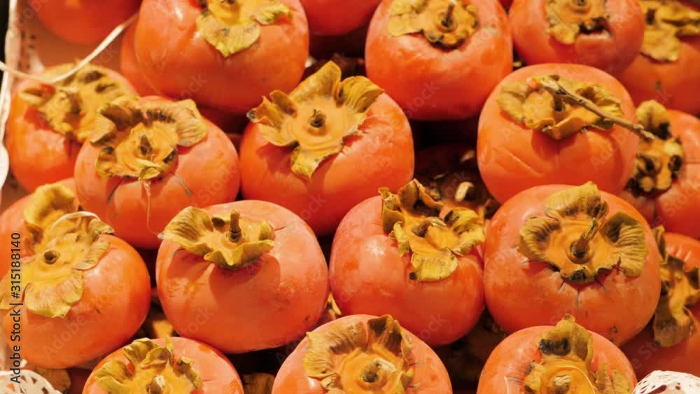 Persimmons fruit at the farmers market Persimmons fruit at the farmers market