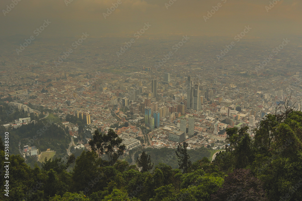 Panorama photo of Colombia capital Bogota, viewed from a high perspective, looking towards the CBD on a hazy misty day. Misty cityscape.