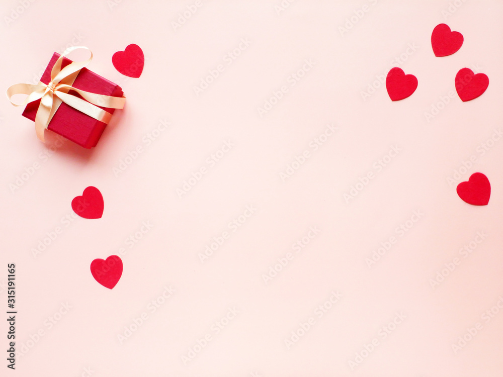 Pink background with gift box and hearts. Saint Valentine's day
