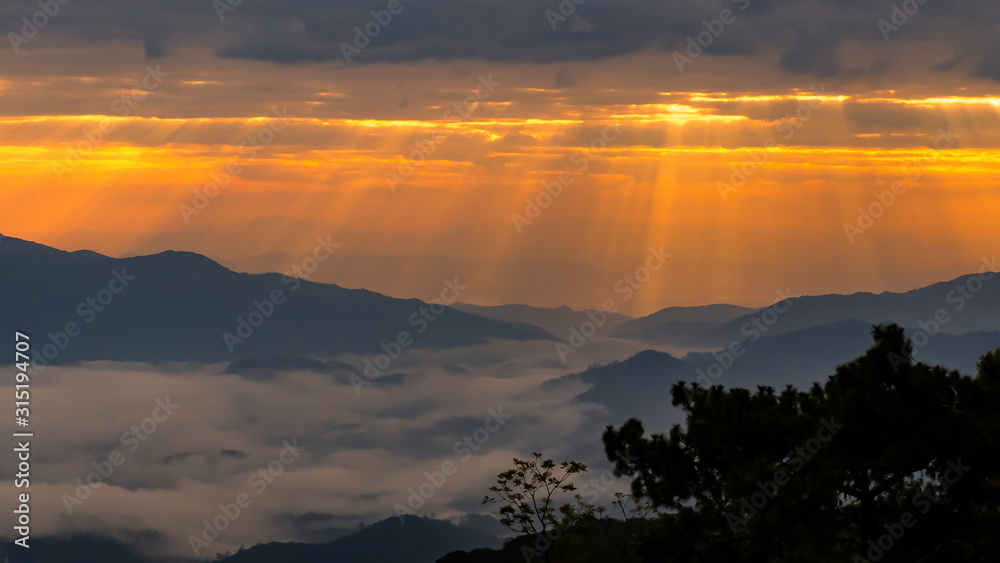 mountain landscape with colorful vivid sunset on the cloudy sky