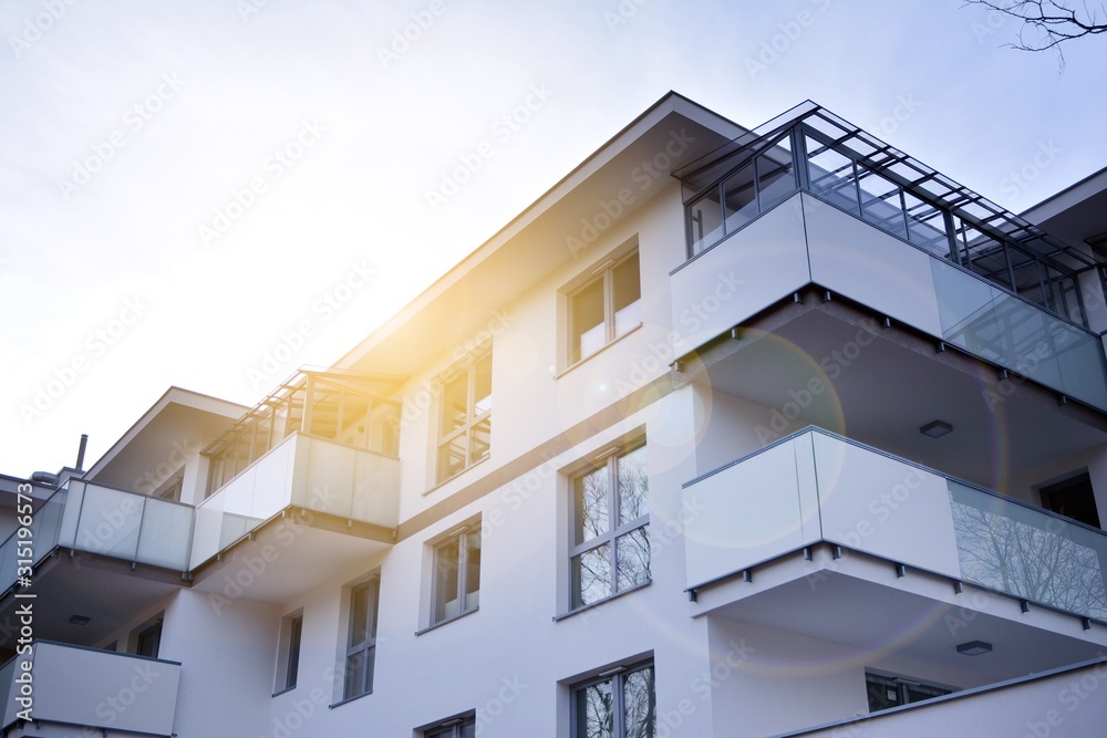 Modern apartment buildings on a sunny day with a blue sky. Facade of a modern apartment building.Glass surface with sunlight.