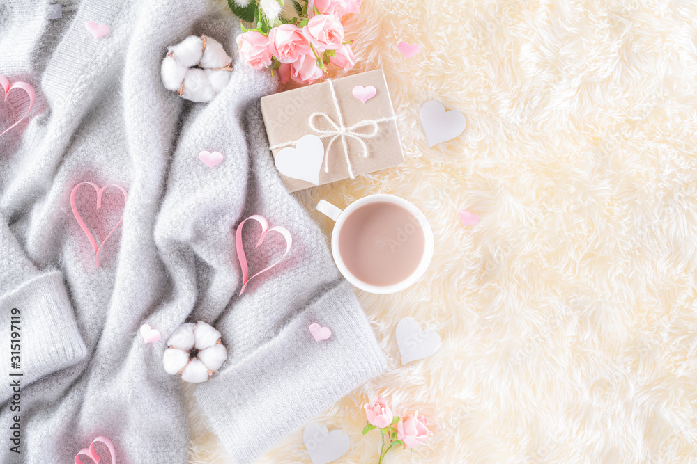 Pink paper hearts with gift box and roses, coffee cup on , beige sweater on cream colour knitted blanket and fluffy background. Love and Valentine's day during Winter concept. Pink paper hearts with gift box and roses, coffee cup on , beige sweater on cream colour knitted blanket and fluffy background. Love and Valentine's day during Winter concept.