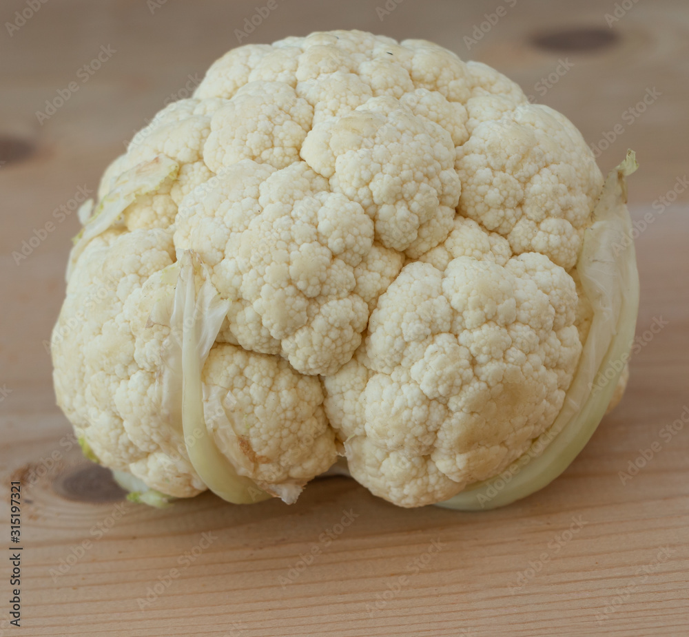 Fresh cauliflower benefits concept. Cauliflower on wooden Background Fresh cauliflower benefits concept. Cauliflower on wooden Background