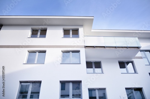 Modern apartment buildings on a sunny day with a blue sky. Facade of a modern apartment building.Glass surface with sunlight.