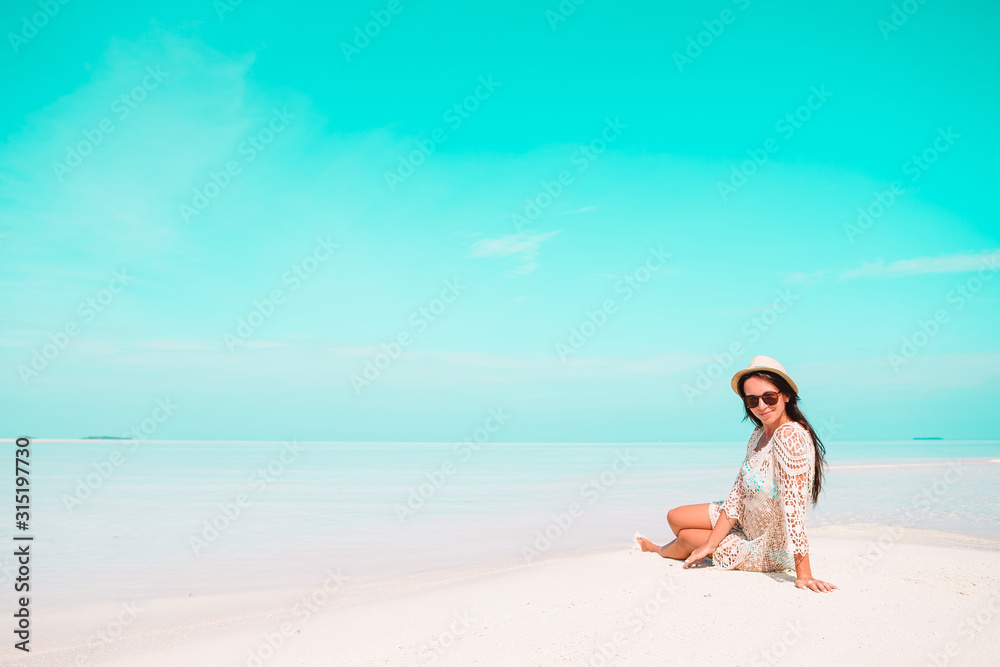 Woman laying on the beach enjoying summer holidays looking at the sea Woman laying on the beach enjoying summer holidays looking at the sea