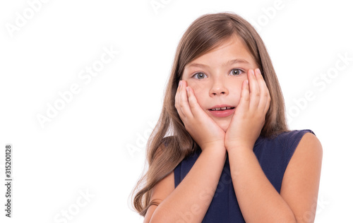 Little girl shows surprise on a white background.