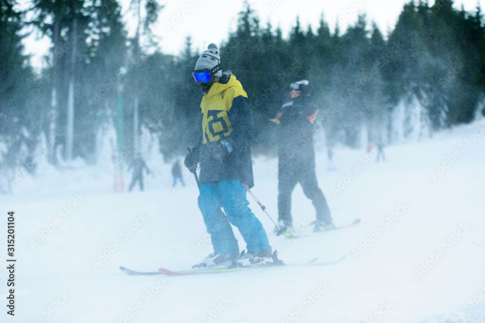 Male skier skiing on ski slope at Donovaly ski resort in Slovakia