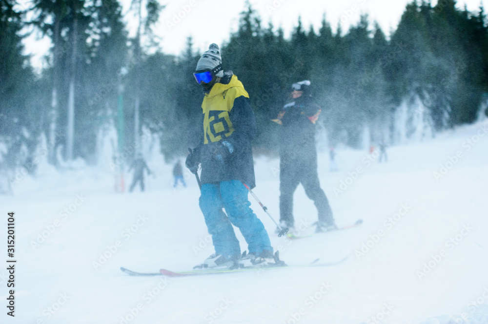 Male skier skiing on ski slope at Donovaly ski resort in Slovakia Male skier skiing on ski slope at Donovaly ski resort in Slovakia