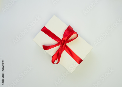 White box, red ribbon white background