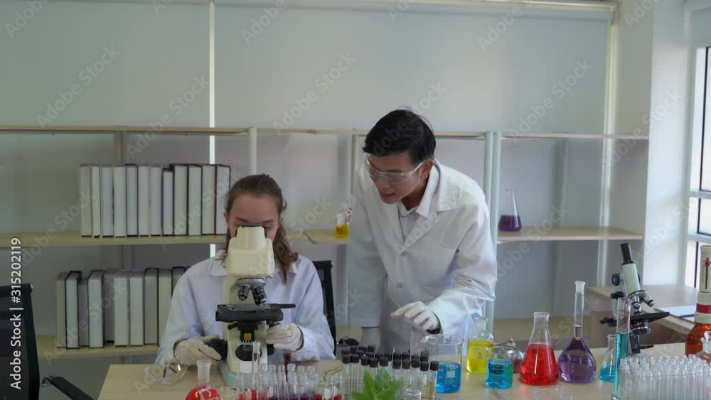 Professors are teaching young scientists to do scientific experiments. Professors are teaching young scientists to do scientific experiments.