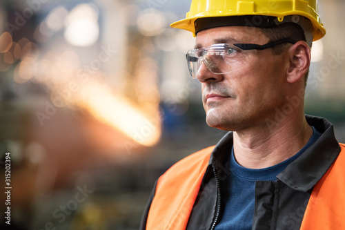 Close up pensive steel worker looking away