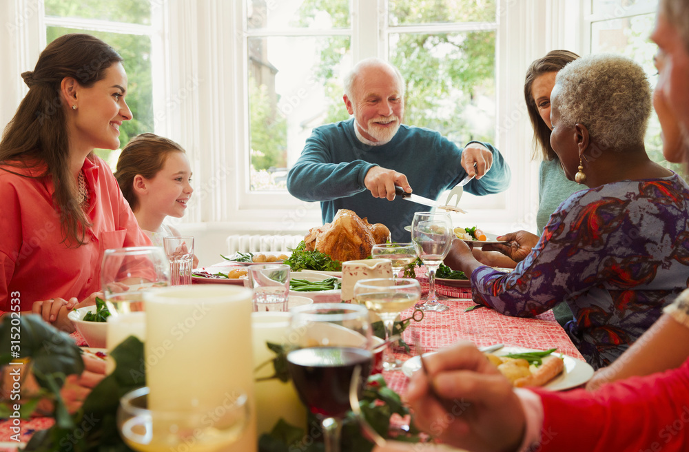 Multi-ethnic family enjoying Christmas dinner table Multi-ethnic family enjoying Christmas dinner table