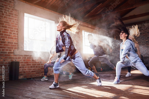 Young women hip hop dancers dancing in studio photo