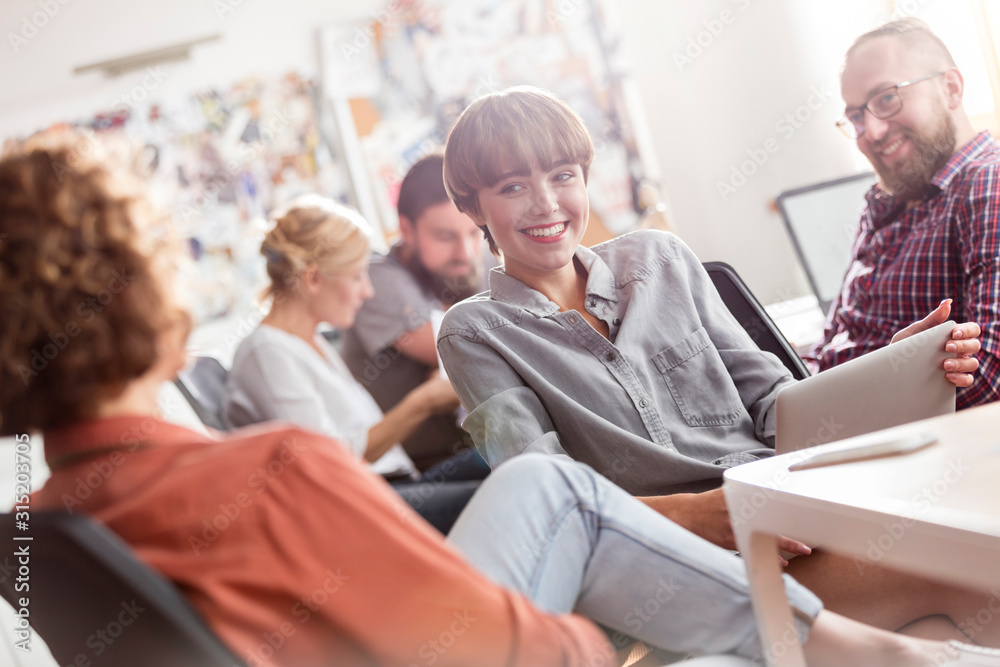 Smiling design professionals with digital tablet meeting in office Smiling design professionals with digital tablet meeting in office
