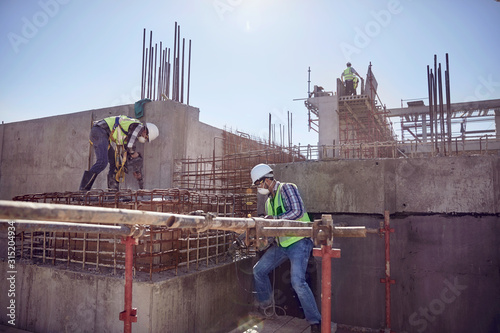 Construction workers working at sunny construction site