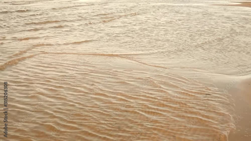 Small relax sea or ocean waves. Slowly splash on sandy coast. Meditating motion of water. Low depth. Shallow depth Small relax sea or ocean waves. Slowly splash on sandy coast. Meditating motion of water. Low depth. Shallow depth