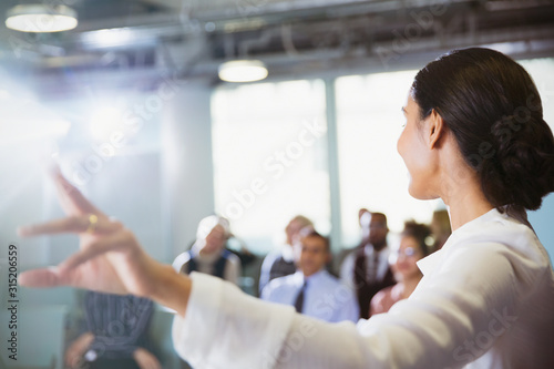 Businesswoman leading conference presentation