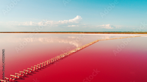 Fototapeta Naklejka Na Ścianę i Meble -  aerial view of pink lake and sandy beach