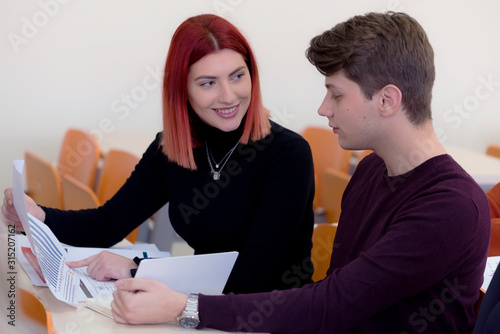 Group of young multietchnic economy students analyzing company annual financial report balance and prepairing for test. Concept picture of economy, education.