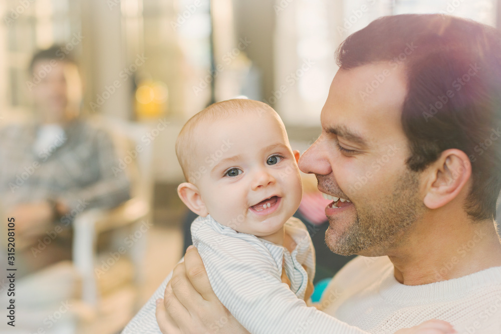 Portrait happy father holding cute baby son Portrait happy father holding cute baby son