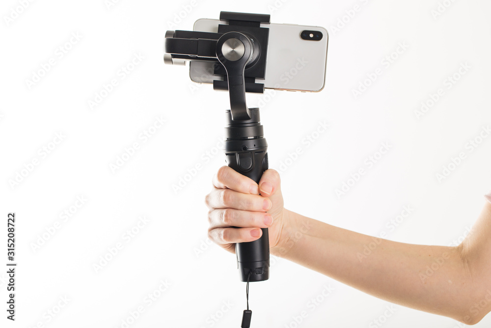 woman hand and gimbal with phone on white background woman hand and gimbal with phone on white background