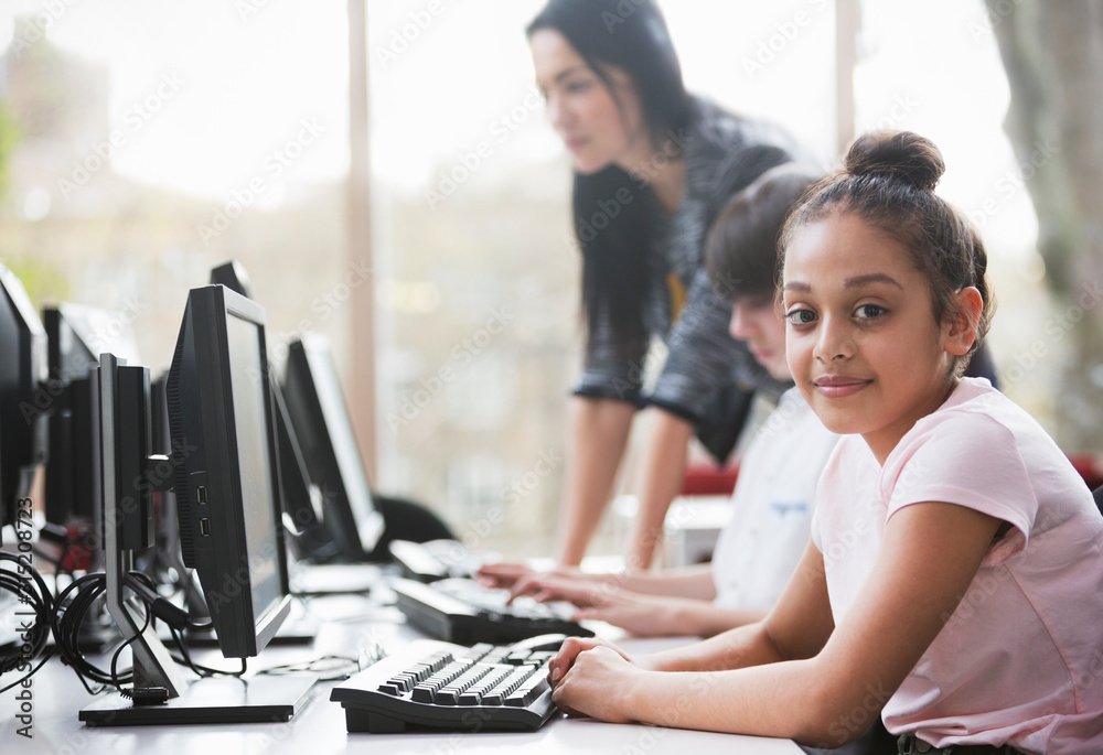 Portrait confident girl student using computer in library Portrait confident girl student using computer in library