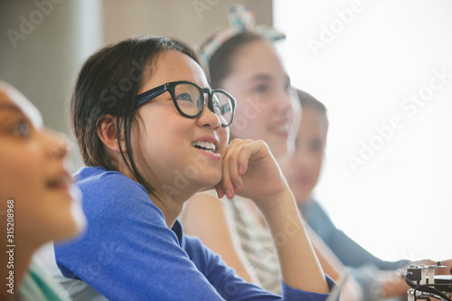 Curious girl student listening in classroom photo