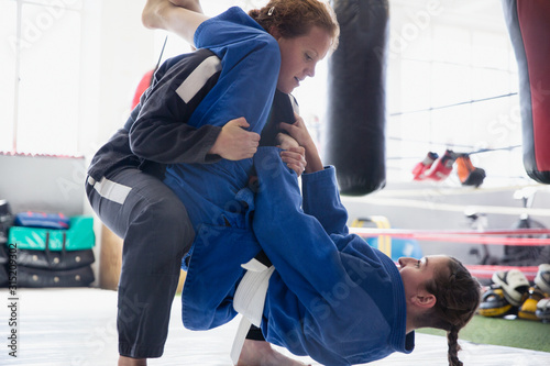 Determined women practicing judo in gym photo