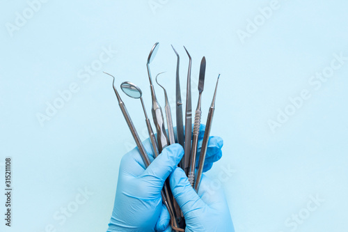 Gloved hand with dental equipment