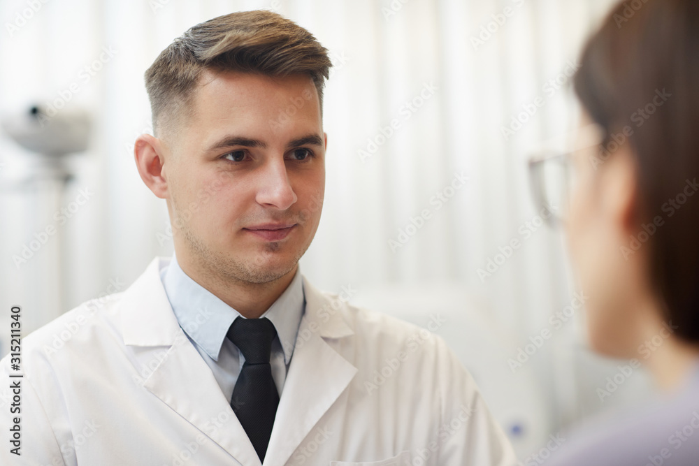 custom made wallpaper toronto digitalClose up portrait of handsome young ophthalmologist listening to female patient during consultation in clinic, copy space