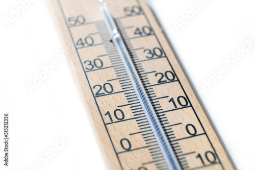 Close up of a wooden wall thermometer