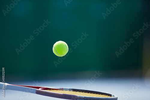 Tennis ball bouncing on tennis racket