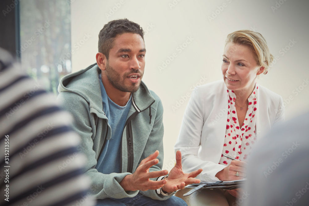 © Caiaimage/Rafal Rodzoch/Caia Image - Young man talking in group therapy session