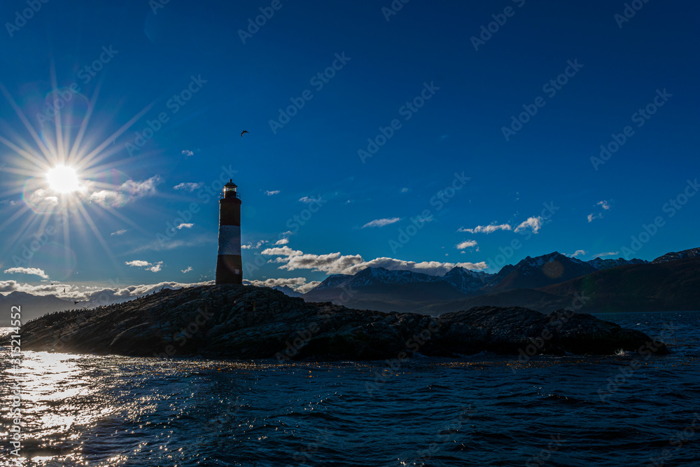 Les Eclaireurs Lighthouse Silhouette against sunlight rays at the end of the world in Ushuaia, Tierra del Fuego, Argentina